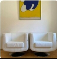 2 White swivel armchairs with chrome base.