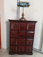 Colonial-style, exotic wooden dresser with 12 drawers. Brown color with a mahogany shade.
