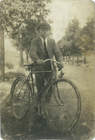1920s. Young man with bicycle. Original paper image. Old photo. Black and white photo sheet, postcard.