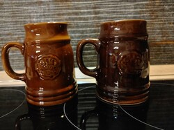 Two ceramic beer mugs, one with a green leaf frog