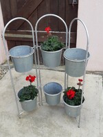 Tin containers (flower stands) on a metal frame
