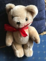 Brand new teddy bear with red bow. Size: 30 cm high and 9 cm wide.