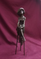 Seated woman in hat with stole. Marked bronze statue.