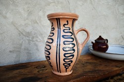 A folk marked glazed ceramic mug