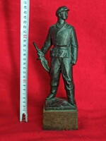 Olcsai little Zoltán workers' guard statue on a wooden plinth