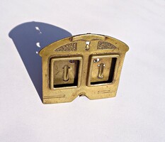 A small double picture frame made of brass, around a hundred years old