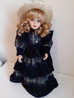 Porcelain doll with a hat-blue