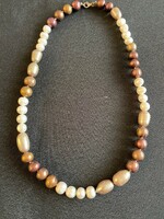 A very beautiful string of cultured pearls of different sizes and colors. New! Custom made!