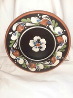Ceramic wall plate with a folk motif