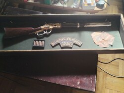 Winchester model 1886 in a carved wooden display case