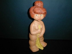 Ceramic figurine of a little girl taking a bath