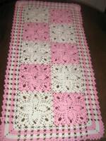 Beautiful antique handmade crochet floral pattern on white-pink-orange tablecloth