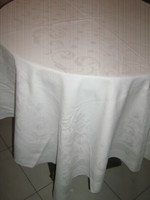 Beautiful baroque floral pattern on white antique damask tablecloth