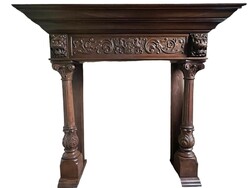 Antique, richly carved fireplace frame