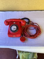 Old working red dial telephone.