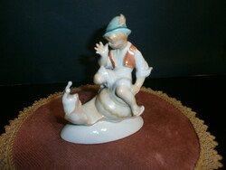Porcelain snail riding boy figurine