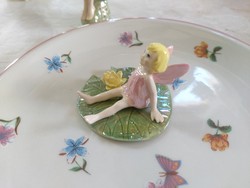 Lake fairy, pixie, charming blonde fairy sitting on a water lily leaf, detailed figure