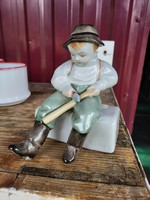 András Sinkó is a small boy carving a stick, a porcelain figure