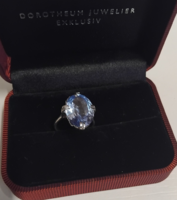 Marked silver ring encrusted with a polished pale blue stone