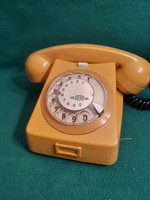 Retro yellow dial phone.
