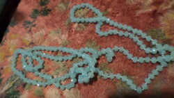 A very long (146 cm) aqua blue, faceted crystal pearl chain, knotted per bead