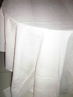 Beautiful baroque floral pattern on white antique damask tablecloth