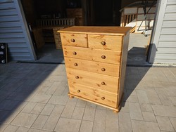 The stained pine chest of drawers shown in the pictures is for sale