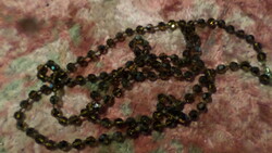 Necklace of 126 cm, brownish luster, faceted crystal beads, knotted in each eye.