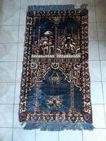 Iranian machine-knotted carpet. Size 110 x 65 cm plus fringe.