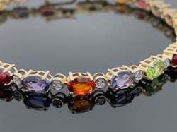 Rhodolite-iolite-peridot-citrine gold bracelet with diamonds. New