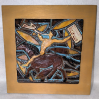 Ceramic wall picture on wooden background