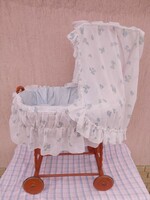 Retro rocking stroller with wooden frame, wicker basket with bedding, sunshade