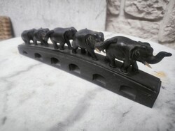 Elephant sculpture group, herd, walking on a bridge. Carved