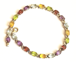 Old silver tennis bracelet with colorful gemstones aquamarine amethyst garnet olivine citrine