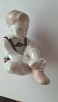 Aquincum porcelain figure – Boy tying his shoe