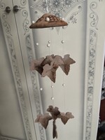 A unique, fairy-like ceramic wind chime.