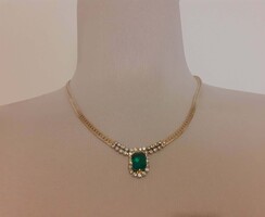 Elegant gold-colored necklace with green and white 