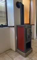 Thalia Octagon stove, with flue pipe, elbow pipe, and wall rose