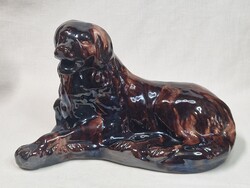 Large glazed ceramic lying dog figurine in good condition, 27 cm long