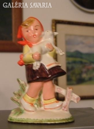 Old ceramic figure. Girl with lamb.