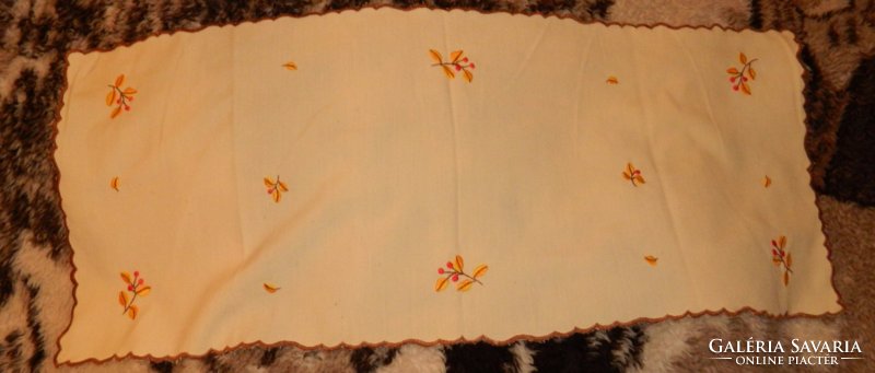 Small flower pattern embroidered tablecloth on a yellow background