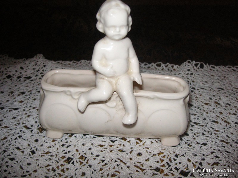 Porcelain holder, marked with putto