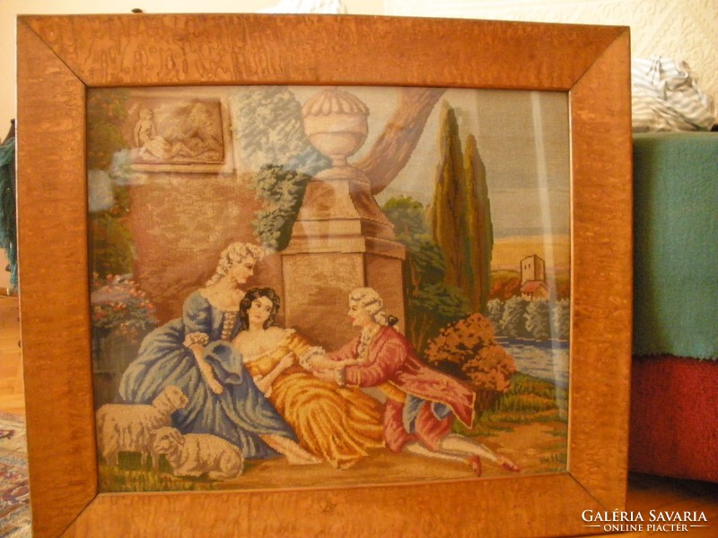 Antique needle tapestry in a beautiful frame behind glass