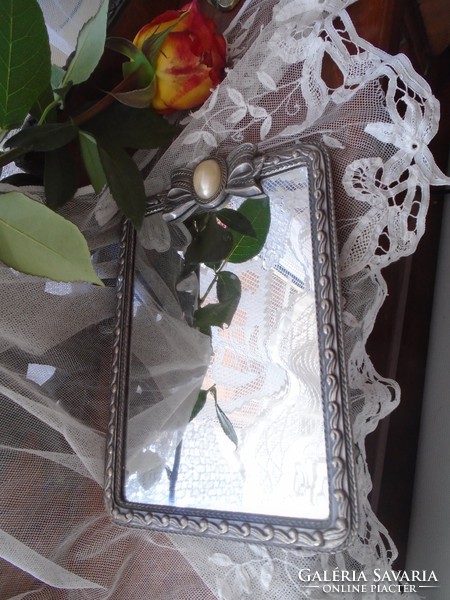 Bow mirror with metal frame.