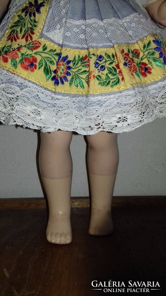 Antique old doll in hand-embroidered folk costume
