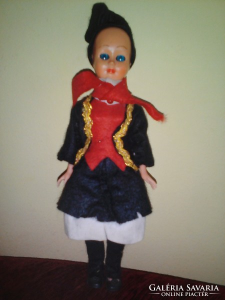 Old plastic doll in folk costume