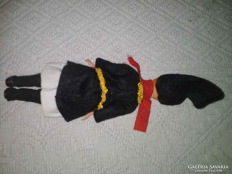 Old plastic doll in folk costume