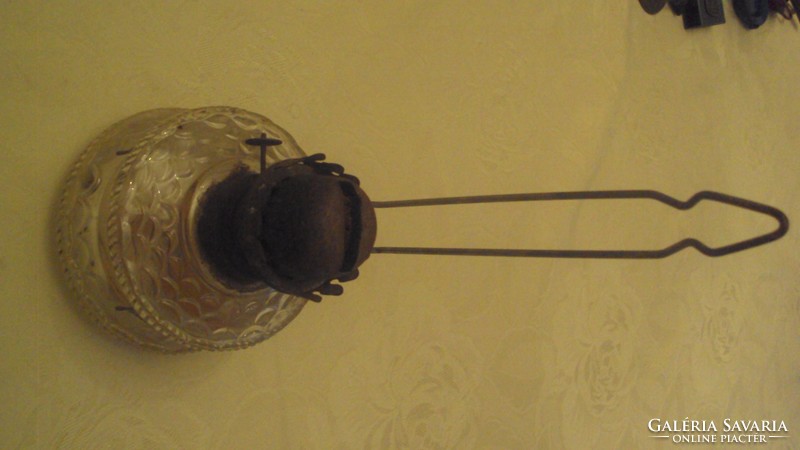 Old kerosene lamp with a glass body that can be hung on the wall.