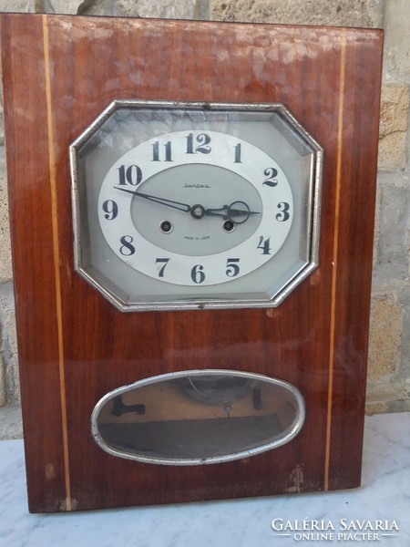 An elegant wall clock with a rare form of old amber