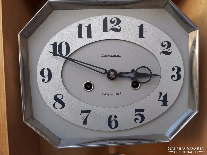 An elegant wall clock with a rare form of old amber